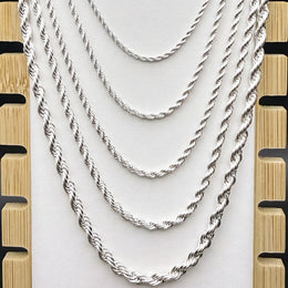 Silver-tone rope chains in graduated widths on a light display bust