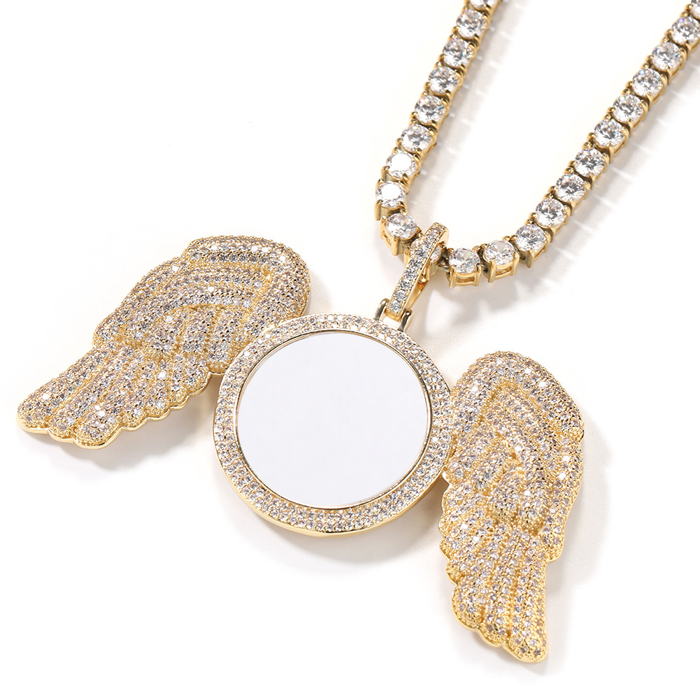 Angled gold-tone angel wings photo pendant showing feather details and the round photo area