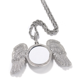 Silver-tone photo pendant showing the feather-shaped wings and stone-set frame