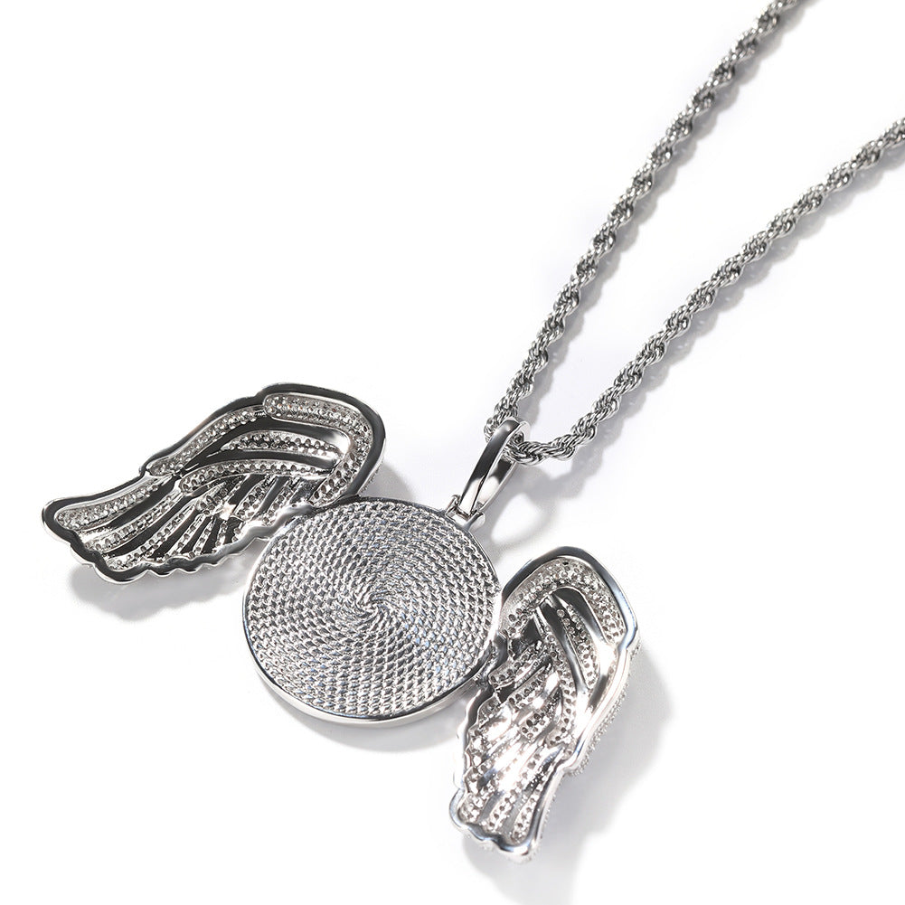 Back of the silver-tone angel wings pendant showing its textured disc and open wing settings