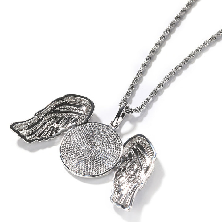 Back of the silver-tone angel wings pendant showing its textured disc and open wing settings