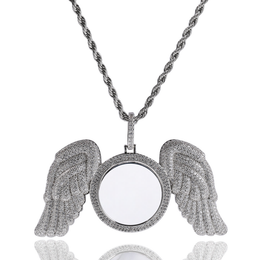 Front view of a silver-tone angel wings photo pendant with a reflection below