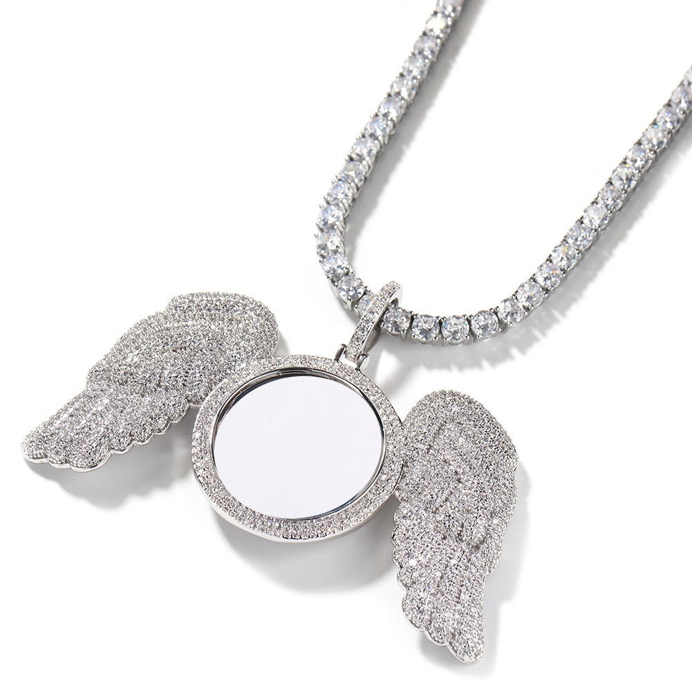 Angled silver-tone angel wings photo pendant showing the raised round frame