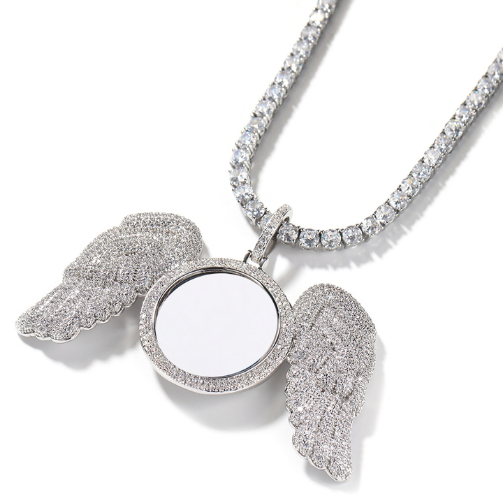Angled silver-tone angel wings photo pendant showing the raised round frame