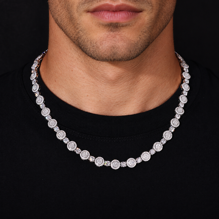Model wearing a silver-tone moissanite tennis chain with circular halo clusters over a black shirt
