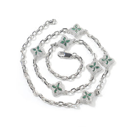 Green four-leaf clover adjustable necklace in a silver-tone setting on white