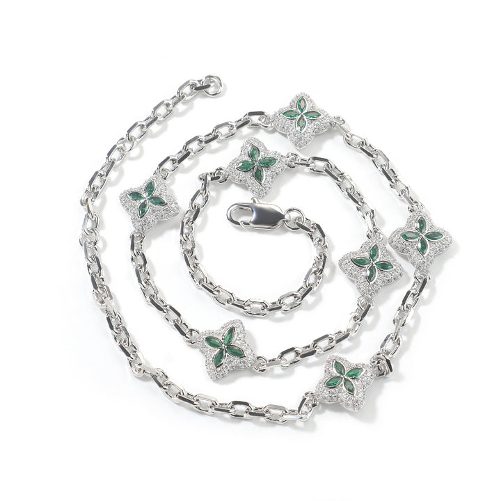 Green four-leaf clover adjustable necklace in a silver-tone setting on white