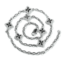 Black four-leaf clover adjustable necklace in a silver-tone setting on white
