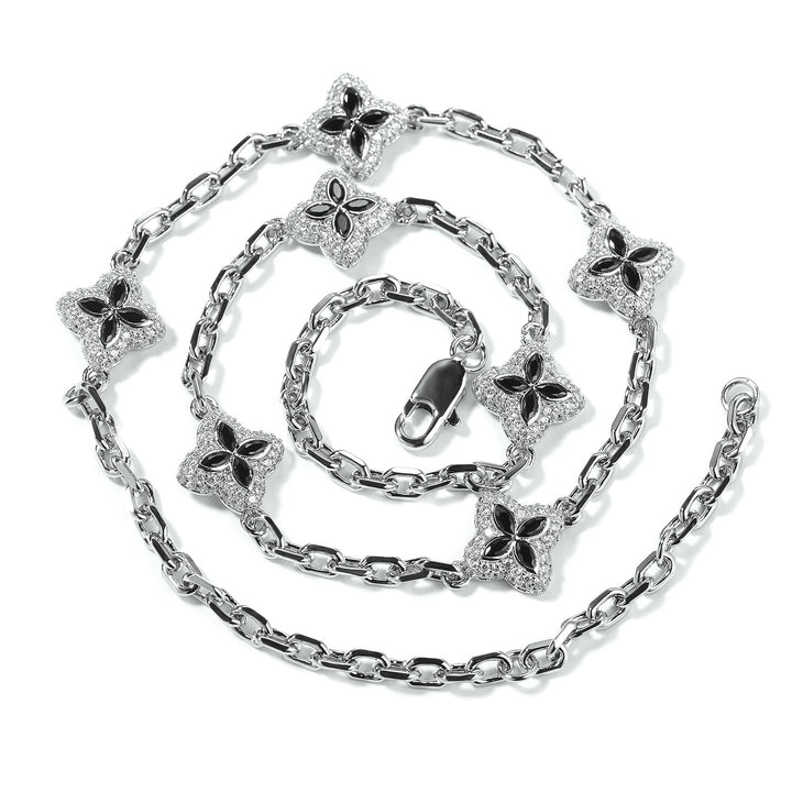 Black four-leaf clover adjustable necklace in a silver-tone setting on white
