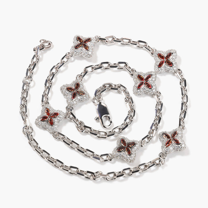 Red four-leaf clover adjustable necklace in a silver-tone setting on white