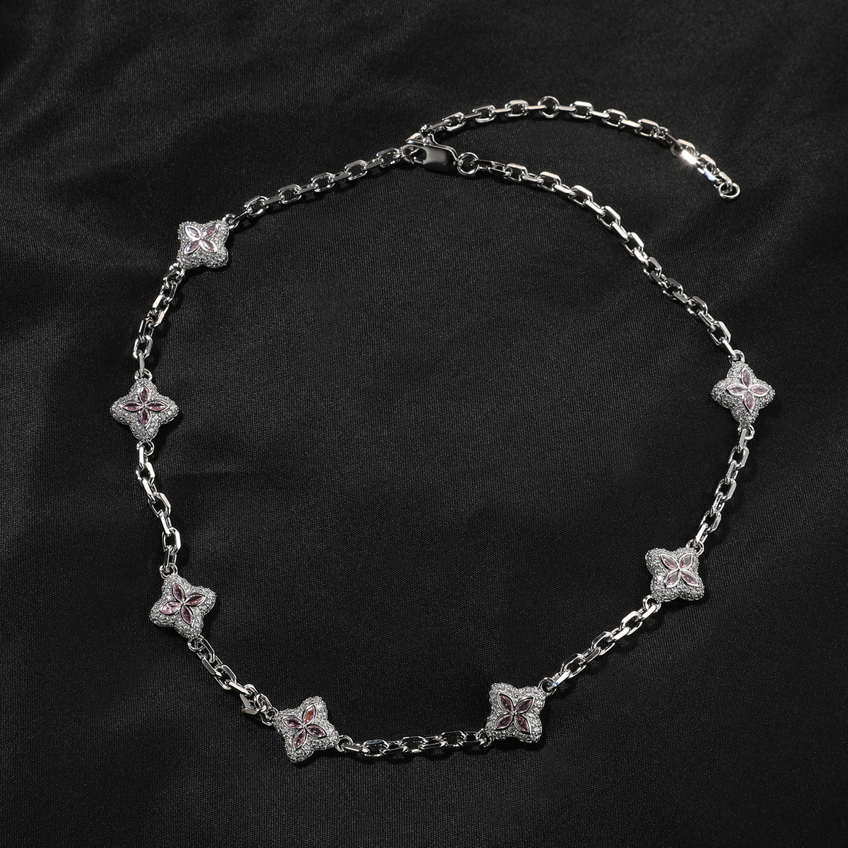 Silver-tone four-leaf clover necklace link and stone detail