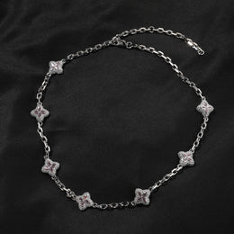 Silver-tone four-leaf clover necklace link and stone detail
