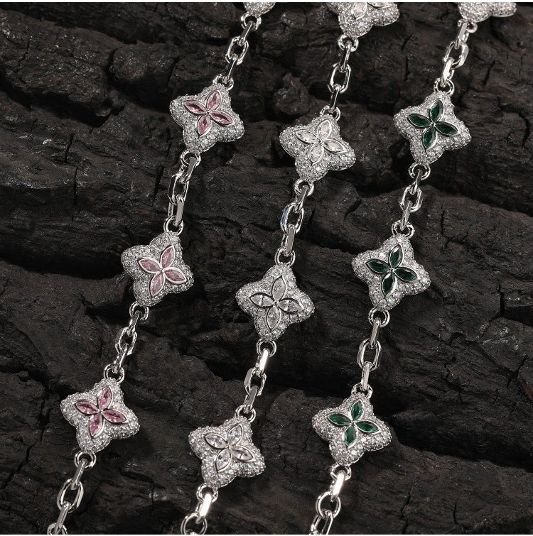 Silver-tone four-leaf clover necklace link and stone detail