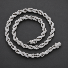 Rope necklace coiled on a dark surface with both ends of its clasp visible