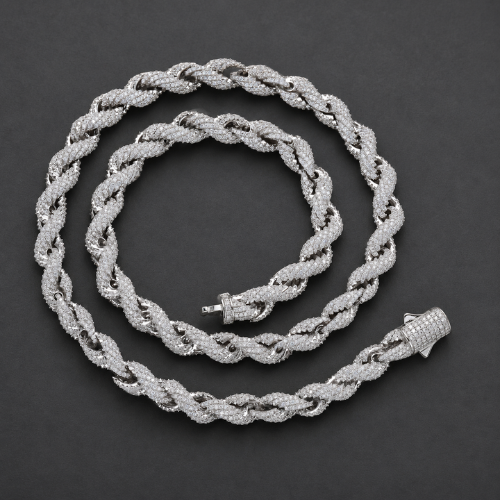 Rope necklace coiled on a dark surface with both ends of its clasp visible