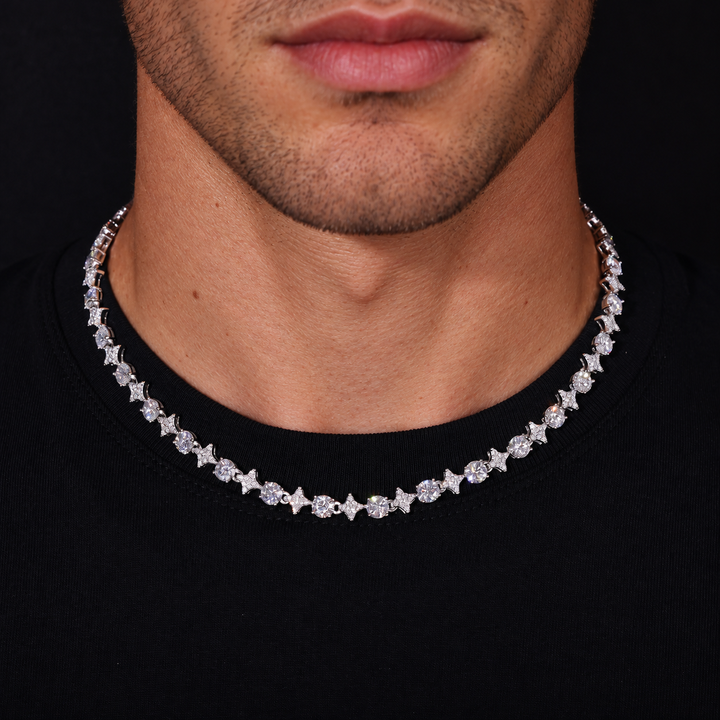 Model wearing a silver-tone moissanite star tennis necklace over a black shirt