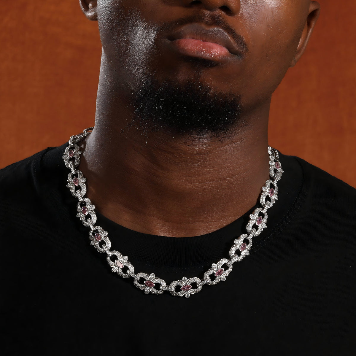 Pink marquise floral link necklace worn over a black crew-neck shirt, front view