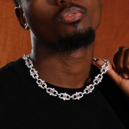Pink marquise floral link necklace worn over a black shirt and held at one side