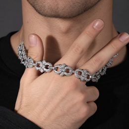 Clear marquise floral link necklace held across a hand near the neck