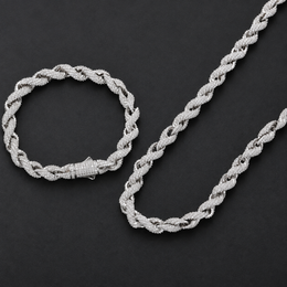 Matching rope bracelet and necklace arranged together on a dark background