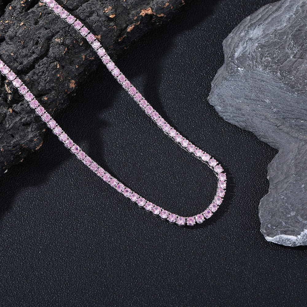 Dark-background detail view of 4mm iced pink CZ tennis chain necklace