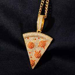 Gold-tone pizza slice pendant with a sparkling bail against dark fabric