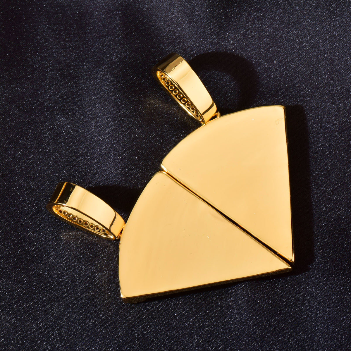 Backs of gold-tone pizza slice pendants showing smooth metal surfaces