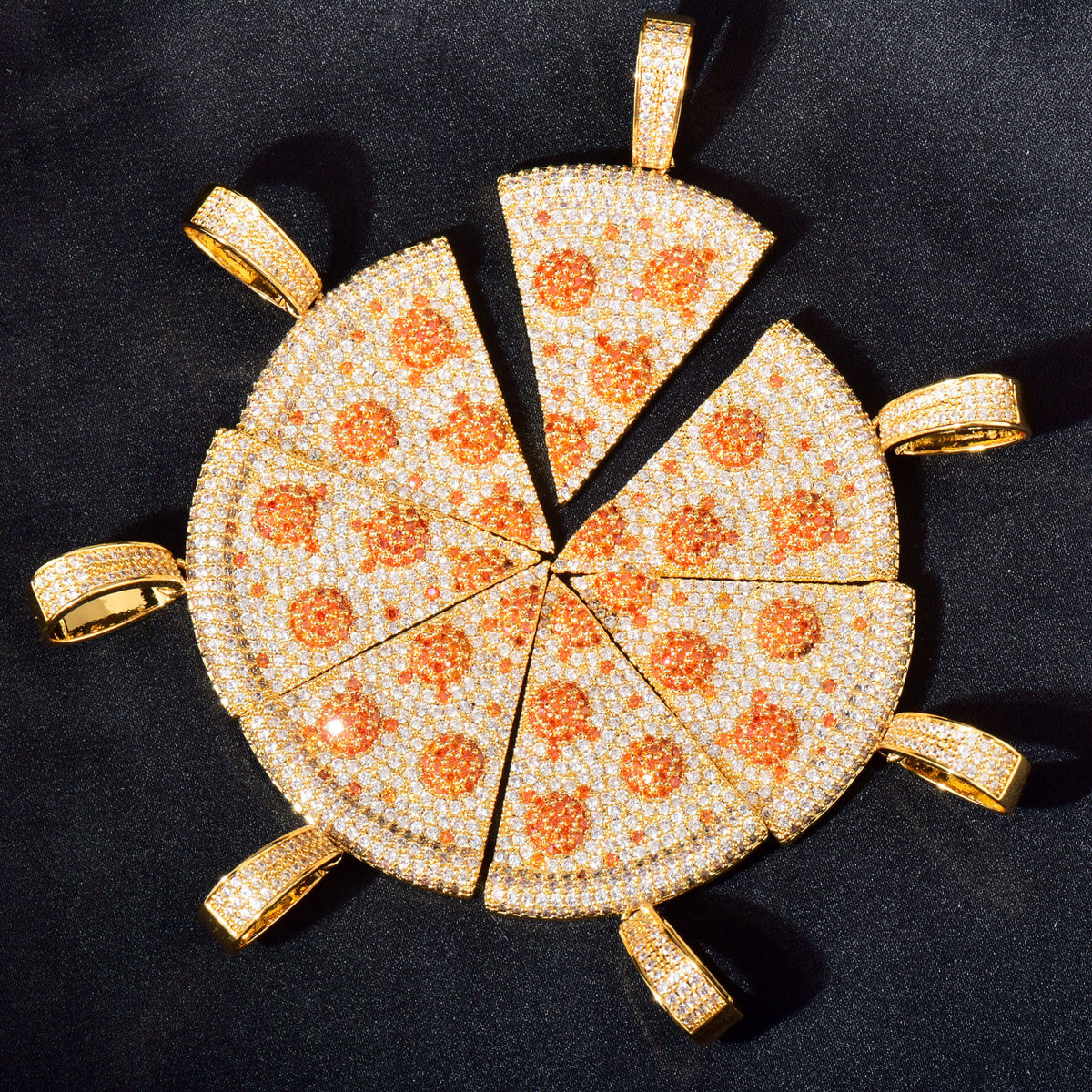 Angled arrangement of gold-tone pizza slice pendants on dark fabric