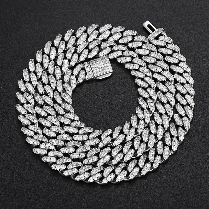 Silver-tone moissanite Cuban chain coiled closely with its clasp visible