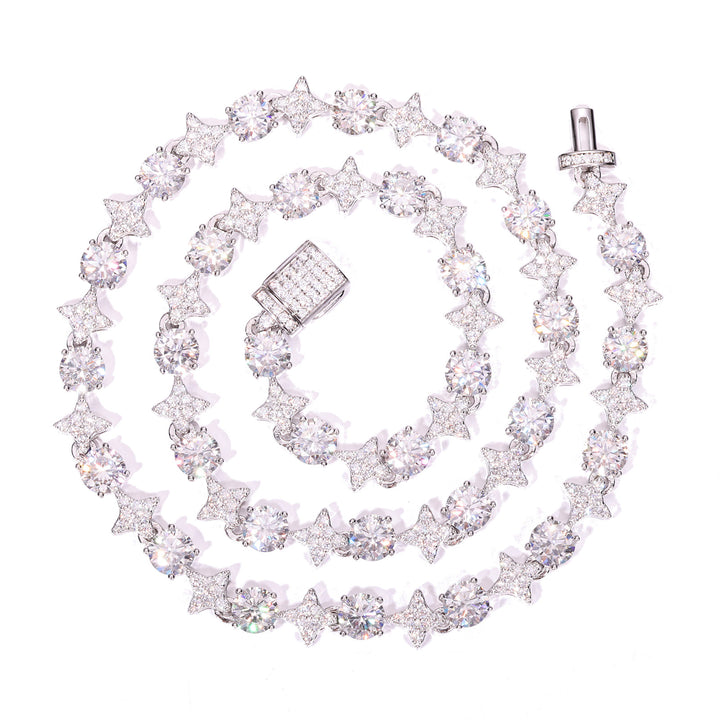 Silver-tone moissanite star tennis necklace coiled on white with an open box clasp