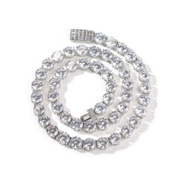 Silver-tone round cubic zirconia tennis chain coiled with the open box clasp visible
