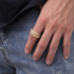 Gold-tone Cuban link ring worn on a relaxed hand against blue jeans