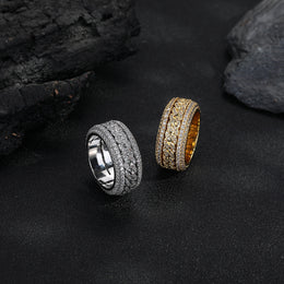 Silver-tone and gold-tone Cuban link rings displayed together on black