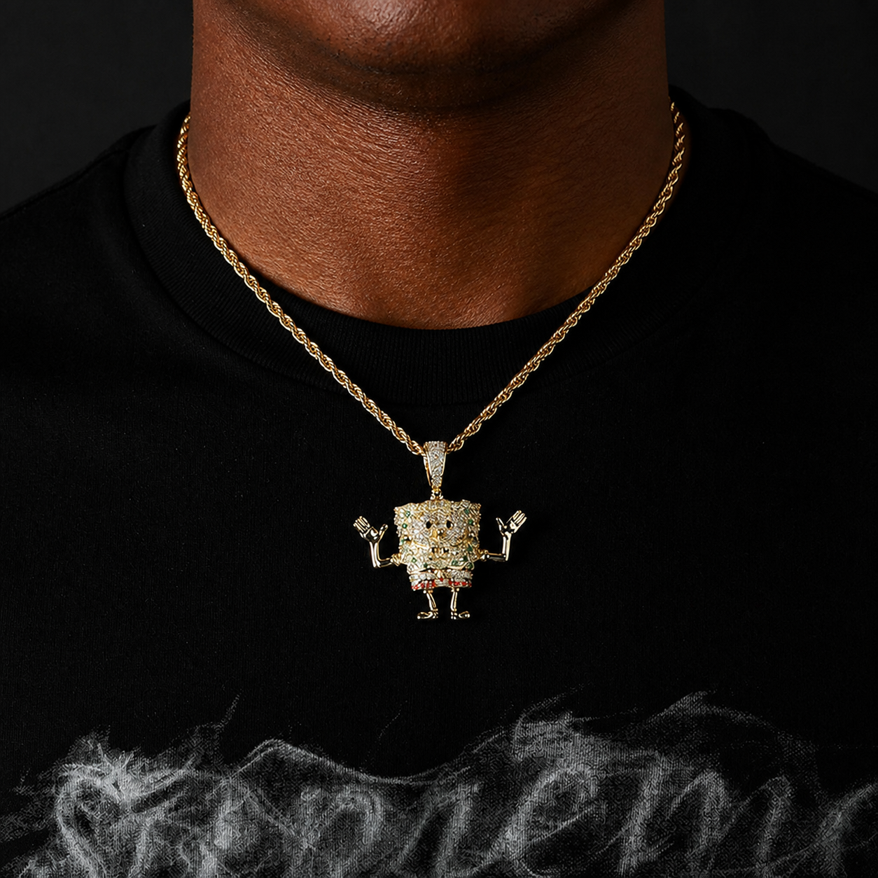 Gold iced cartoon sea sponge pendant worn by a deep-brown model