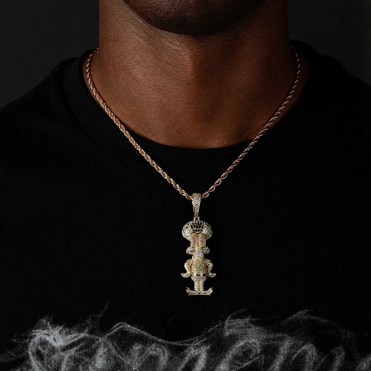 Gold iced cartoon squid character pendant worn by a deep-brown model