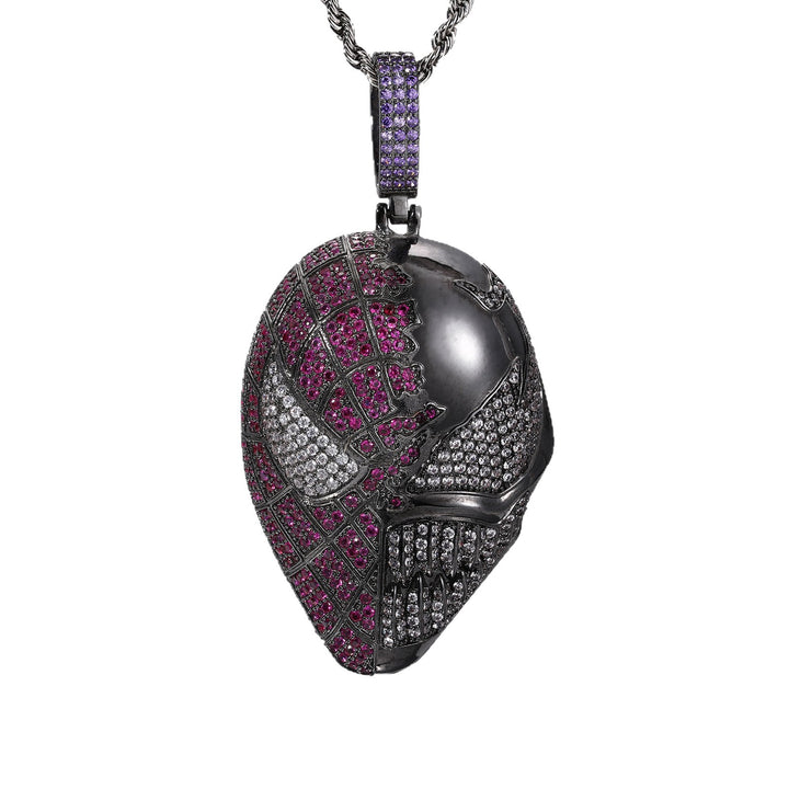 Dark silver-tone fanged mask pendant with pink and clear stones and a purple bail on white