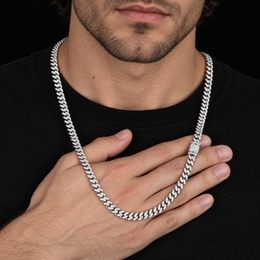 Model holding a silver-tone moissanite Cuban chain across a hand, with the clasp visible