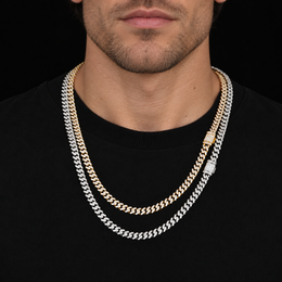 Model wearing silver-tone and gold-tone moissanite Cuban chains together over a black shirt