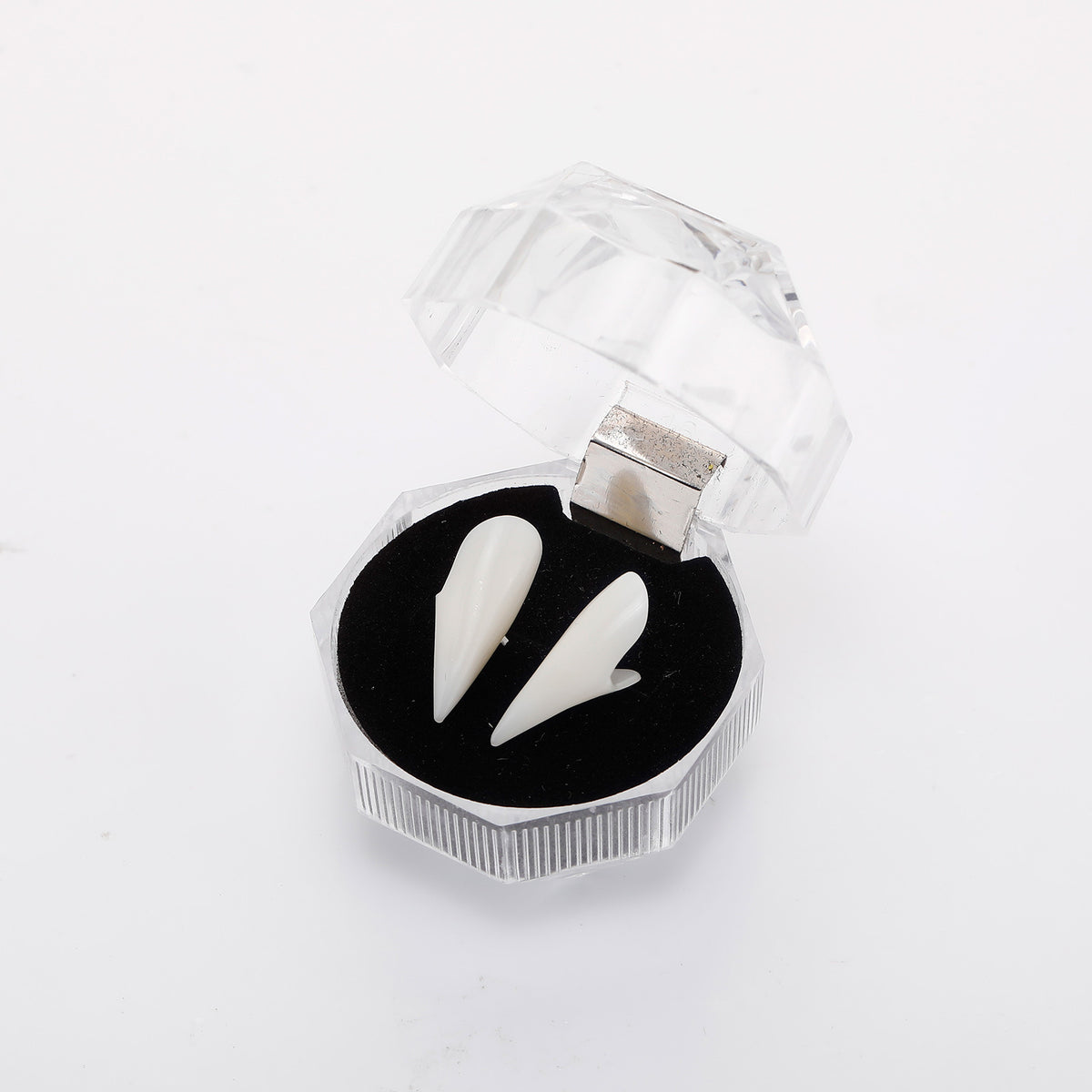 White vampire fangs in an open clear hinged display box