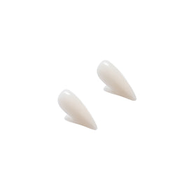 Pair of white vampire fang caps viewed from the side
