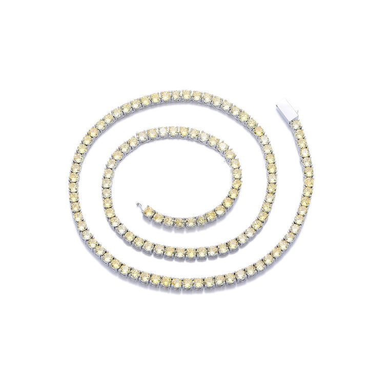 Yellow-stone tennis necklace arranged in a spiral on white