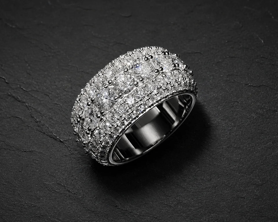 Iced statement ring on a dark surface